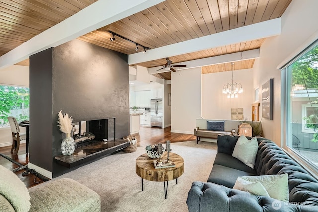 11446 Ohde Ave, Kirkland, WA 98033 - living room featuring rail lighting, a chandelier, a wooden ceiling with exposed beams, a ceiling fan, and wood finished floors