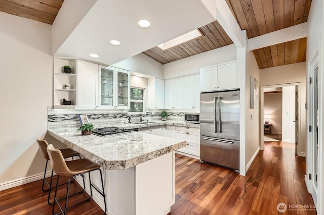 11446 Ohde Ave, Kirkland, WA 98033 - kitchen with appliances with stainless steel finishes, a peninsula, wooden ceiling, decorative backsplash, and white cabinets