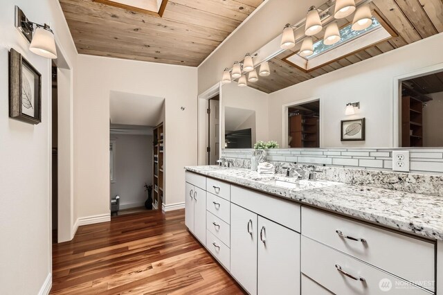 11446 Ohde Ave, Kirkland, WA 98033 - bathroom with wooden ceiling, double vanity, wood finished floors, and a skylight