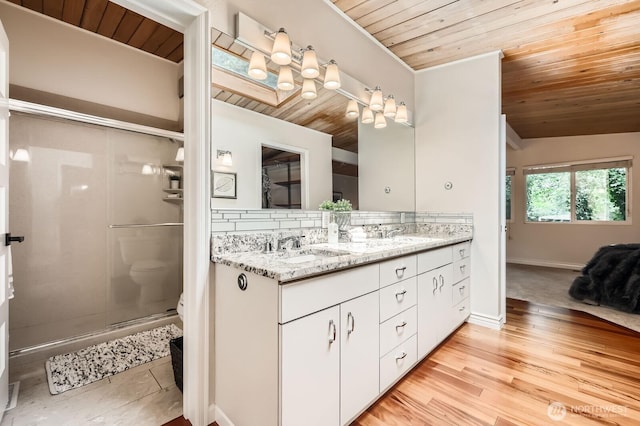 11446 Ohde Ave, Kirkland, WA 98033 - full bathroom featuring wood ceiling, double vanity, a shower stall, tasteful backsplash, and wood finished floors