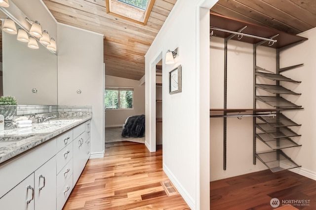 11446 Ohde Ave, Kirkland, WA 98033 - bathroom featuring wooden ceiling, vanity, wood finished floors, lofted ceiling, and a skylight