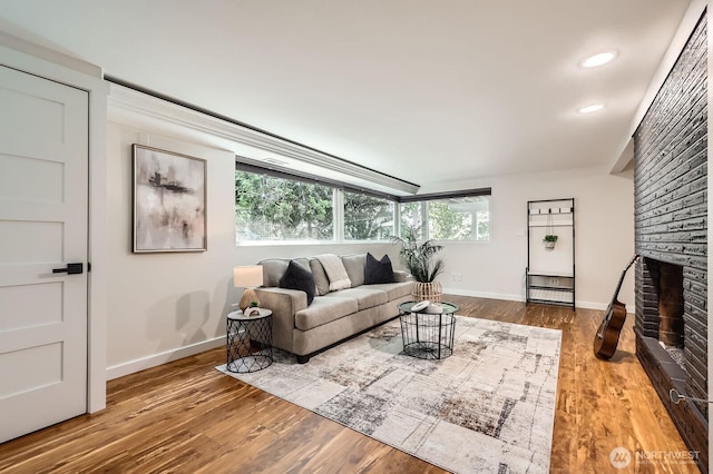 11446 Ohde Ave, Kirkland, WA 98033 - living room featuring wood finished floors, recessed lighting, and a brick fireplace