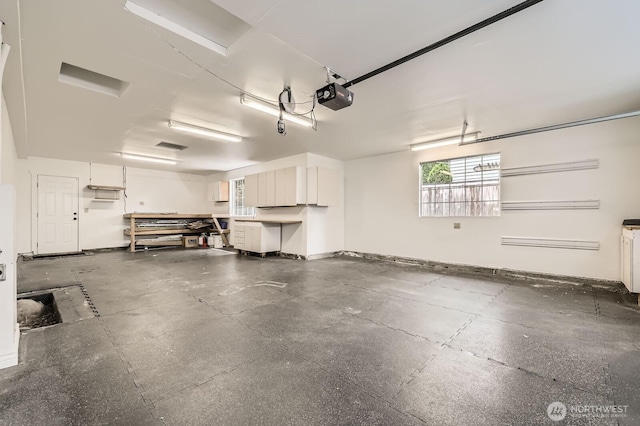 11446 Ohde Ave, Kirkland, WA 98033 - garage featuring a garage door opener and baseboards