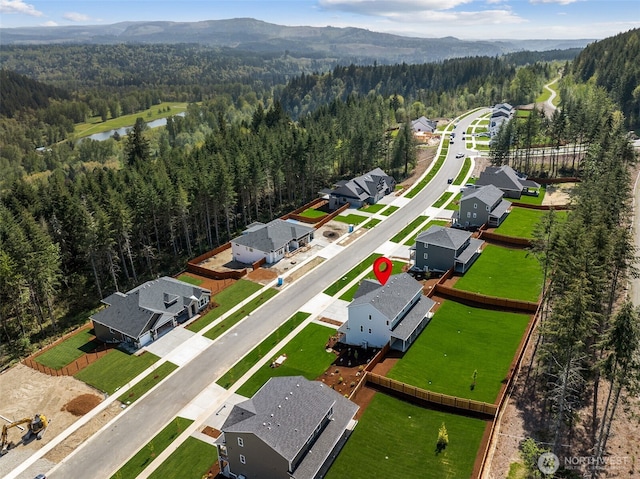 15410 210th Ave E Unit 316, Bonney Lake, WA 98391 - aerial perspective of suburban area featuring a heavily wooded area and a water and mountain view