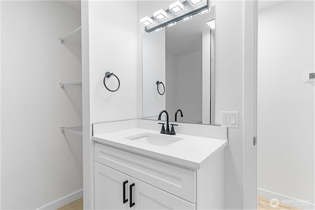 7611 Easy St, Everett, WA 98203 - bathroom with vanity, a spacious closet, and wood finished floors