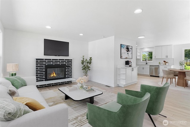 7611 Easy St, Everett, WA 98203 - living area featuring light wood-style floors, a tile fireplace, and recessed lighting