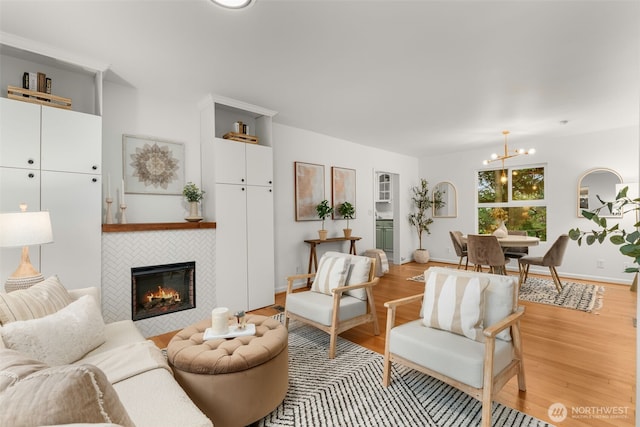 15516 10th Ave NE, Shoreline, WA 98155 - living area with a fireplace, a chandelier, and light wood finished floors