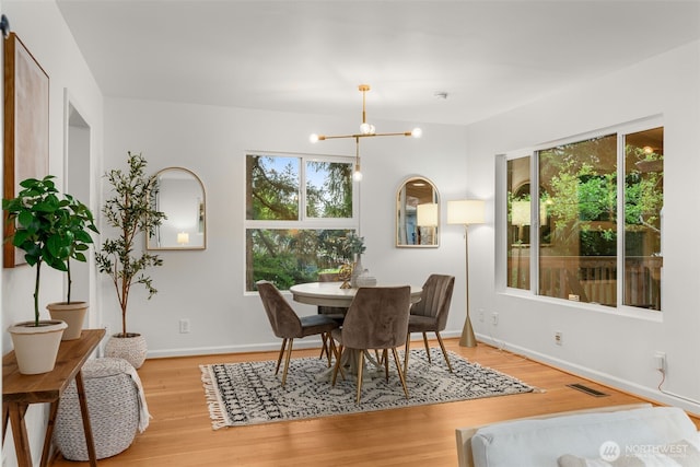 15516 10th Ave NE, Shoreline, WA 98155 - dining room with light wood finished floors and a chandelier