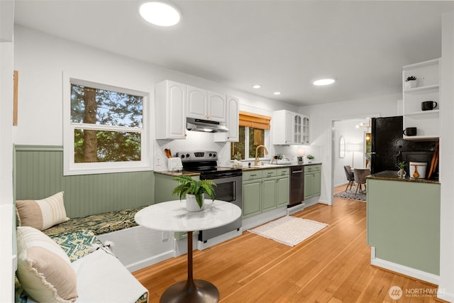 15516 10th Ave NE, Shoreline, WA 98155 - kitchen featuring under cabinet range hood, stainless steel range with electric stovetop, dishwashing machine, white cabinets, and a wainscoted wall