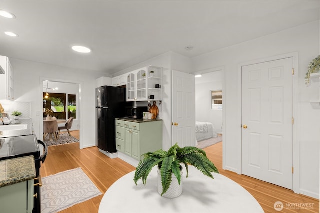 15516 10th Ave NE, Shoreline, WA 98155 - kitchen featuring freestanding refrigerator, stove, green cabinets, light wood-style flooring, and recessed lighting
