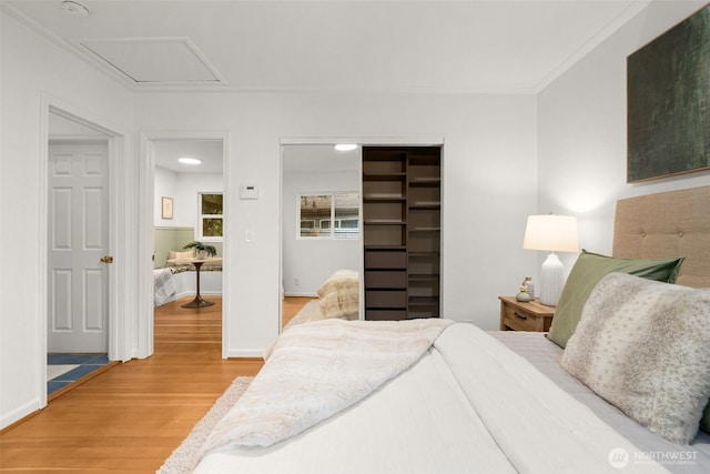 15516 10th Ave NE, Shoreline, WA 98155 - bedroom featuring light wood-type flooring, a closet, ornamental molding, and a spacious closet
