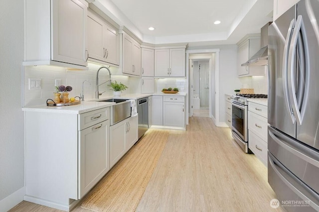 950 Beckett Point Rd, Port Townsend, WA 98368 - kitchen with appliances with stainless steel finishes, wall chimney exhaust hood, decorative backsplash, light countertops, and recessed lighting