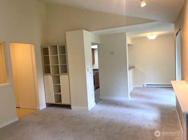 12617 NE 130th Way Unit E303, Kirkland, WA 98034 - carpeted empty room with baseboard heating and baseboards