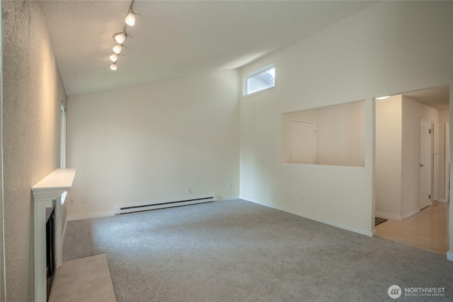 12617 NE 130th Way Unit E303, Kirkland, WA 98034 - unfurnished living room with a baseboard heating unit, rail lighting, and carpet flooring