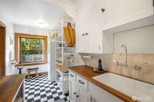 1631 16th Ave Unit 114, Seattle, WA 98122 - kitchen with butcher block counters, dark floors, white cabinets, backsplash, and open shelves
