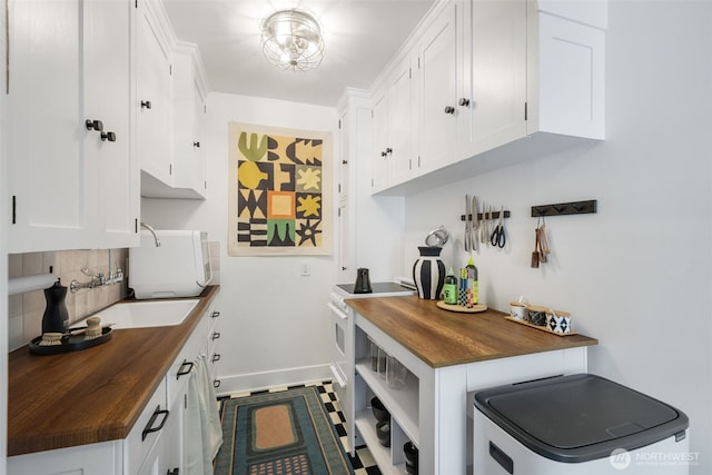 1631 16th Ave Unit 114, Seattle, WA 98122 - kitchen with wooden counters, white appliances, decorative backsplash, white cabinetry, and open shelves