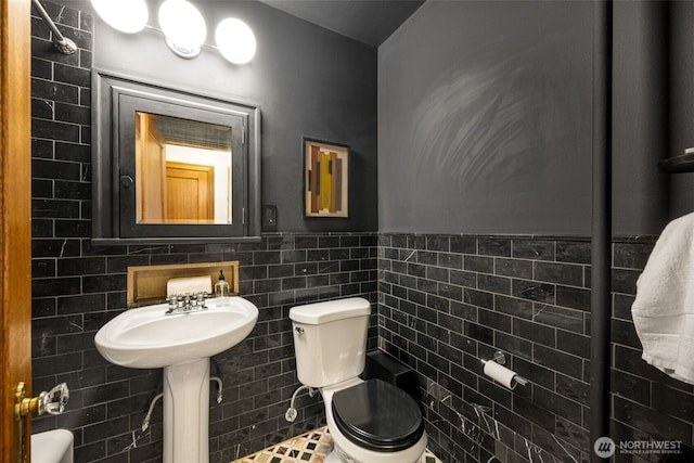 1631 16th Ave Unit 114, Seattle, WA 98122 - half bathroom featuring tile walls and wainscoting