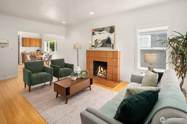 4754 46th Ave NE, Seattle, WA 98105 - living area with ornamental molding, a tile fireplace, light wood-type flooring, and recessed lighting