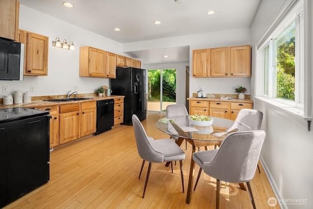 4754 46th Ave NE, Seattle, WA 98105 - kitchen featuring black appliances, light wood-type flooring, light countertops, and recessed lighting