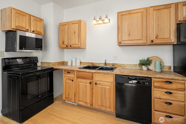 4754 46th Ave NE, Seattle, WA 98105 - kitchen featuring black appliances, light wood-type flooring, and light countertops