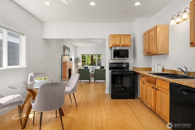 4754 46th Ave NE, Seattle, WA 98105 - kitchen with black appliances, light wood finished floors, recessed lighting, and light countertops