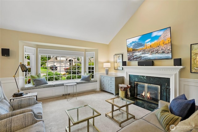 2601 59th St SW, Everett, WA 98203 - living room featuring a premium fireplace, a wainscoted wall, light carpet, and high vaulted ceiling