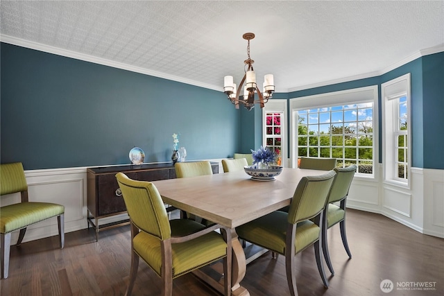2601 59th St SW, Everett, WA 98203 - dining area featuring a chandelier, wood finished floors, a decorative wall, ornamental molding, and wainscoting