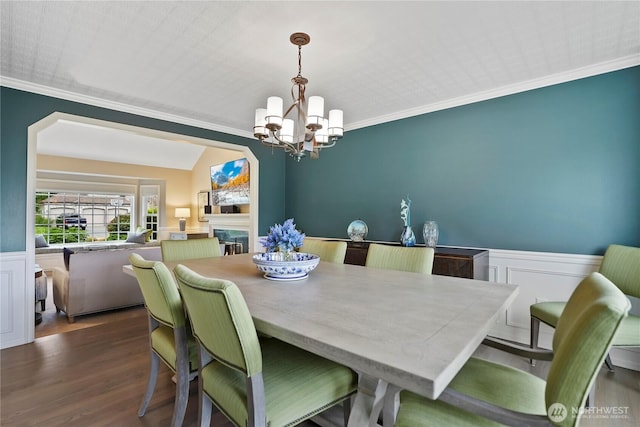 2601 59th St SW, Everett, WA 98203 - dining space featuring a chandelier, ornamental molding, a wainscoted wall, dark wood-type flooring, and a decorative wall