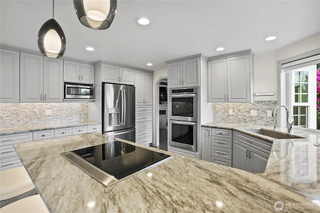 2601 59th St SW, Everett, WA 98203 - kitchen featuring appliances with stainless steel finishes, gray cabinets, decorative backsplash, light stone counters, and recessed lighting