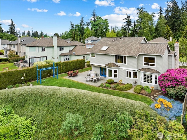 2601 59th St SW, Everett, WA 98203 - back of property with a patio area, a lawn, a residential view, and entry steps