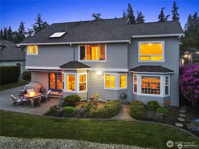 2601 59th St SW, Everett, WA 98203 - rear view of house with a patio, roof with shingles, a fire pit, and a yard