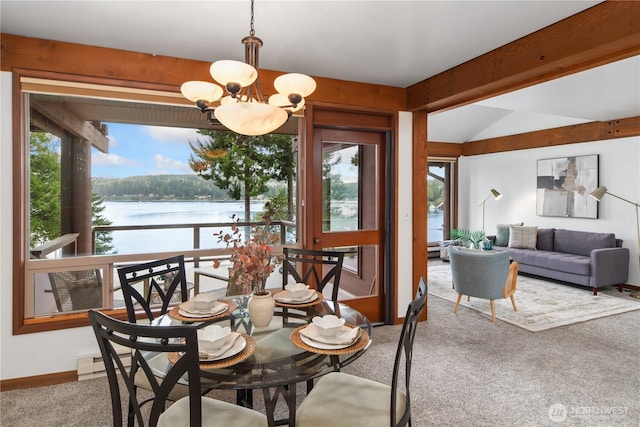 41 N Bay Ln Unit 3, Port Ludlow, WA 98365 - dining room featuring a chandelier, a water view, carpet flooring, vaulted ceiling, and healthy amount of natural light