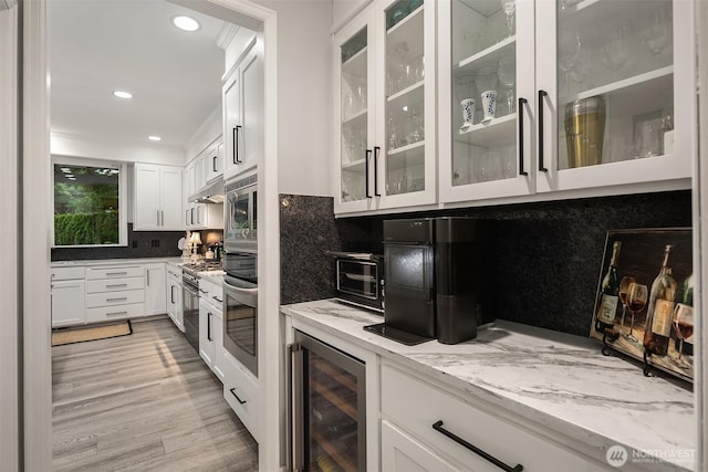 8907 NE 152nd Pl, Bothell, WA 98011 - kitchen with beverage cooler, light stone countertops, white cabinets, tasteful backsplash, and light wood-style flooring