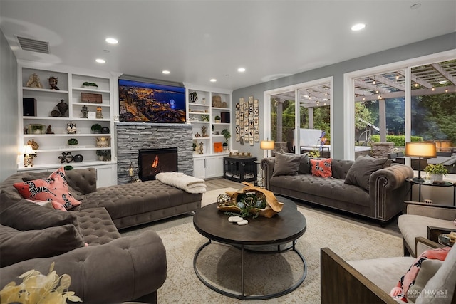 8907 NE 152nd Pl, Bothell, WA 98011 - living room with recessed lighting, a stone fireplace, wood finished floors, and built in shelves