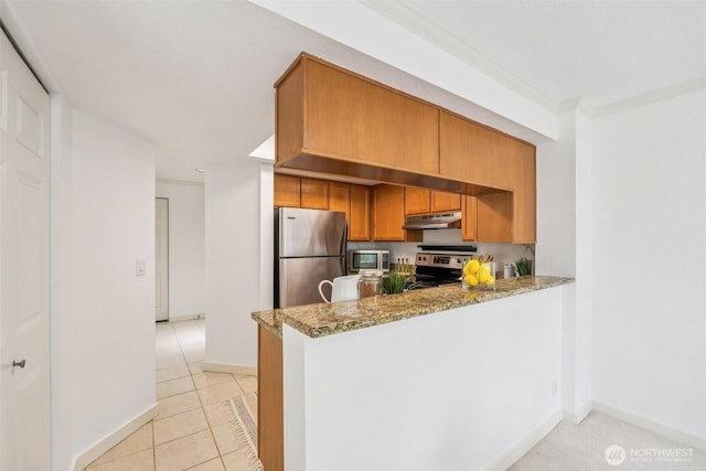 10004 100th Ave NE Unit K202, Kirkland, WA 98034 - kitchen with appliances with stainless steel finishes, under cabinet range hood, light stone countertops, light tile patterned floors, and brown cabinetry