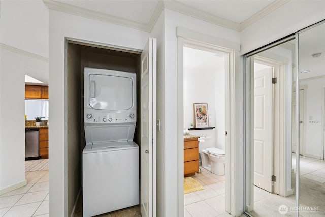10004 100th Ave NE Unit K202, Kirkland, WA 98034 - laundry room with stacked washing machine and dryer, ornamental molding, and light tile patterned floors