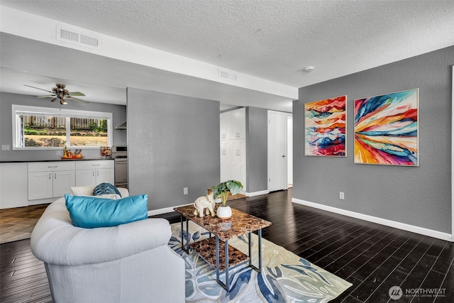 16318 128th Pl SE, Renton, WA 98058 - living area with a textured ceiling, a textured wall, dark wood-style floors, and a ceiling fan