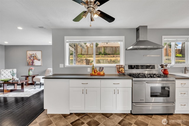 16318 128th Pl SE, Renton, WA 98058 - kitchen with wall chimney range hood, gas range, recessed lighting, white cabinets, and dark countertops