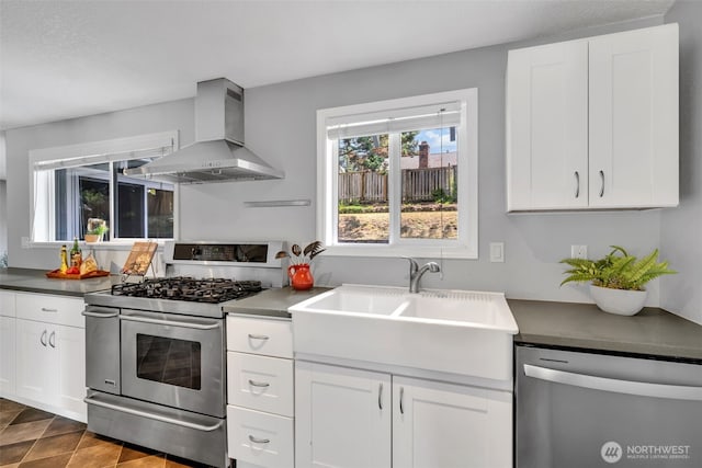 16318 128th Pl SE, Renton, WA 98058 - kitchen with wall chimney exhaust hood, appliances with stainless steel finishes, white cabinetry, and dark countertops