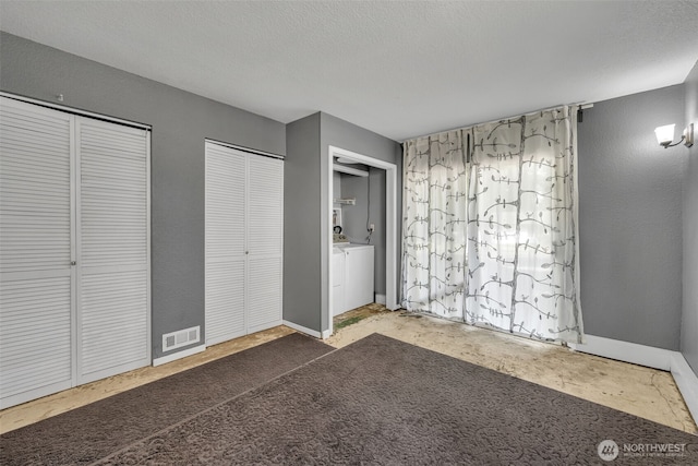16318 128th Pl SE, Renton, WA 98058 - unfurnished bedroom featuring multiple closets and a textured ceiling