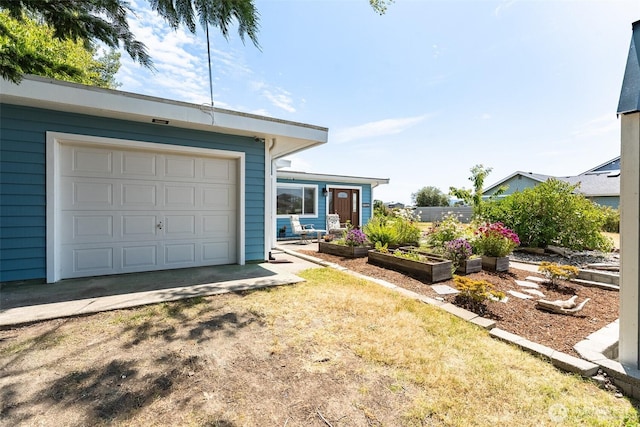 4452 Saltspring Dr, Ferndale, WA 98248 - view of front facade featuring a vegetable garden and a garage