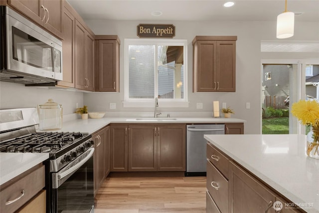 803 Loves Hill Dr, Sultan, WA 98294 - kitchen with appliances with stainless steel finishes, light wood-type flooring, plenty of natural light, light countertops, and recessed lighting