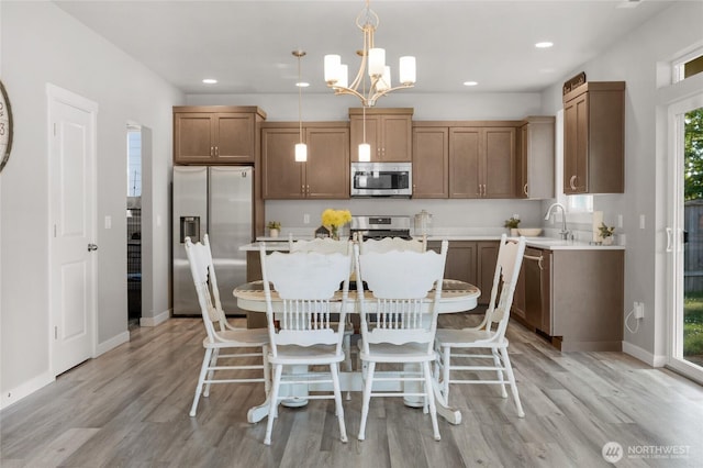803 Loves Hill Dr, Sultan, WA 98294 - kitchen featuring appliances with stainless steel finishes, a chandelier, light wood finished floors, a center island, and recessed lighting