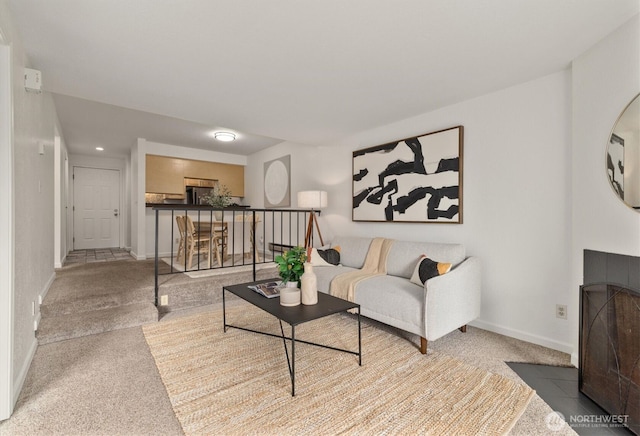 9484 Redmond-Woodinville Rd NE Unit C-205, Redmond, WA 98052 - carpeted living area featuring baseboards and a tiled fireplace