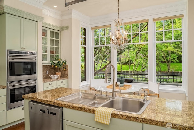 101 W Comstock St Unit 101, Seattle, WA 98119 - kitchen featuring appliances with stainless steel finishes, hanging light fixtures, a chandelier, light countertops, and ornamental molding