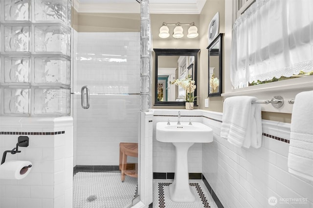 2234 Main St, Ferndale, WA 98248 - bathroom featuring tile walls, a stall shower, tile patterned floors, crown molding, and wainscoting