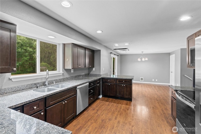 29319 132nd Ave E, Graham, WA 98338 - kitchen featuring stainless steel appliances, wood finished floors, dark brown cabinetry, recessed lighting, and a peninsula