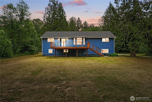29319 132nd Ave E, Graham, WA 98338 - back of property at dusk with a deck, a yard, and stairs