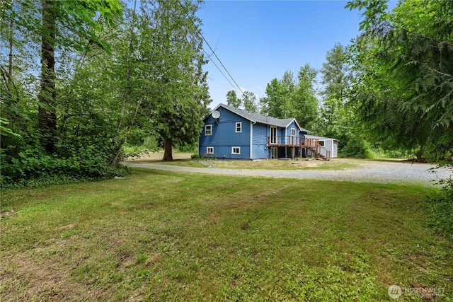 29319 132nd Ave E, Graham, WA 98338 - view of side of home featuring a yard and a wooden deck