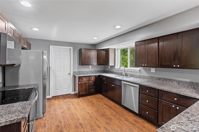 29319 132nd Ave E, Graham, WA 98338 - kitchen featuring dishwasher, dark brown cabinetry, light wood-style floors, range with electric stovetop, and light stone countertops